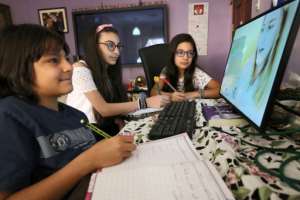 Students attend an online class at home in Kuwait City. By Yasser Al-Zayyat (AFP)