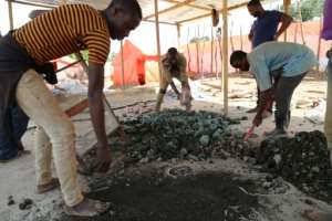 Subsistence miners sort out cobalt and other minerals by a road in southeastern DR Congo. By SAMIR TOUNSI (AFP/File)
