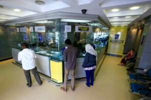 Sudanese wait in January 2020 to exchange money in the capital Khartoum, which has been pushing for a removal from the US list of state sponsors of terrorism. By ASHRAF SHAZLY (AFP/File)