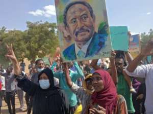Sudanese anti-coup protesters carry the portrait of Prime Minister Abdalla Hamdok during a gathering in the capital Khartoum's twin city of Omdurman on October 30, 2021. By - (AFP/File)