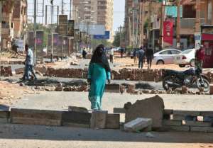Sudanese anti-coup protesters use bricks to barricade a street in the capital Khartoum on October 27, 2021, amid ongoing demonstrations against a military takeover that has sparked widespread international condemnation. By - (AFP)
