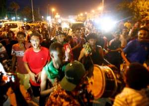 Sudanese celebrate on the streets as word spreads in the early hours of the hard-won deal between protest leaders and the ruling generals. By ASHRAF SHAZLY (AFP)