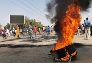 Sudanese demonstrators gather by burning tyres in the capital Khartoum, on October 26, 2021, the day after the coup. By - (AFP)