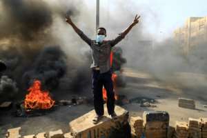 Sudanese protesters burn tyres to block a road in 60th Street in the capital Khartoum, to denounce overnight detentions by the army of members of Sudan's government, on October 25, 2021. Armed forces detained Sudan's Prime Minister over his refusal to support their