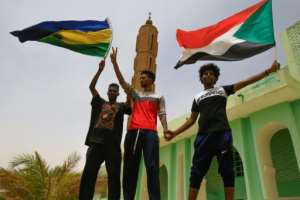 Sudanese protesters, seen here waving the country's former and current national flags, have been locked in a months-long standoff with military generals who have resisted calls to hand power to civilians. By ASHRAF SHAZLY (AFP)