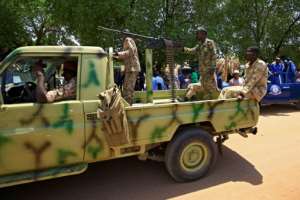 Sudanese security forces guard the courthouse during the trial of Bashir along with 27 co-accused. By ASHRAF SHAZLY (AFP)
