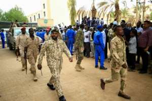 Sudanese security forces deploy outside the Khartoum courthouse during the trial of Bashir and 27 co-accused. By ASHRAF SHAZLY (AFP)