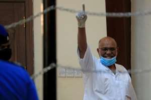 Sudan's ousted president Omar al-Bashir gestures during his trial in the capital Khartoum on October 20, 2020. By Ebrahim HAMID (AFP)