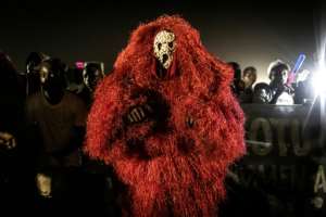 Supporter: A man wears a traditional mask during Barrow's final campaign rally. By JOHN WESSELS (AFP)