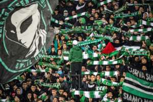 Supporters of Raja Club Athletic chant slogans and wave flags at a Moroccan football match between Raja and Mouloudia Oujda in January. By FADEL SENNA (AFP)