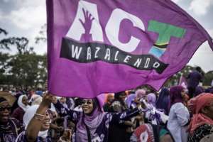 Supporters of the Tanzanian opposition political party The Alliance for Change and Transparency wave flags during a last campaign rally. By MARCO LONGARI (AFP/File)
