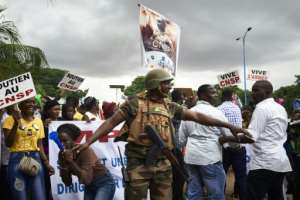 Supporters of the junta celebrate during a demonstration in Bamako at the start of talks. By MICHELE CATTANI (AFP)