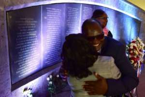 Survivors of the 1998 bombing of the US embassy in Nairobi embrace in 2018 as they stand beside a plaque bearing the names of those killed. By TONY KARUMBA (AFP/File)