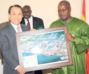 Flashback: Kang Duk-soo, Chairman of STX Group presents an artist's impression of the proposed houses to Vice President Mahama. Behind them is B.K. Asamoah