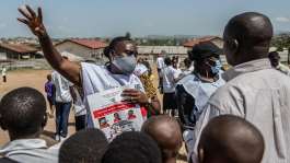 A Red Cross volunteer speaks to people during a public awareness campaign in Bunia, DRC, where the current outbreak began on 15 May. -  AP Photo / Moses Sawasawa