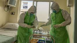 Two nurses in their Personal Protection Equipment (PPE) prepare to receive a patient with a highly infectious disease such as Ebola, during a simulation exercise at the special isolation ward of the department of Infectious Diseases Unit (IDU) at the the Kenyatta National hospital in Nairobi on 12 June, 2026. - AFP - SIMON MAINA