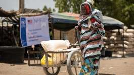 Yakura Usman, 70, walks after receiving food assistance at a distribution centre from where WFP provides relief, including in-kind food rations, electronic food vouchers, and specialized nutrition support for vulnerable households and internally displaced persons in Dikwa, Borno State, Nigeria, May 13, 2026. - via REUTERS - Khalid Hamza