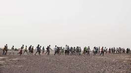 In this July 14, 2019 photo, smugglers lead Ethiopian migrants in Obock, Djibouti to embark on a route via Yemen to reach oil-rich Saudi Arabia to earn enough to escape poverty. - AP - Nariman El-Mofty