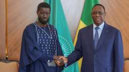 Outgoing Senegalese President Macky Sall shaking hands with with Senegals president-elect Bassirou Diomaye Faye at the Presidential palace in Dakar, on 28 March, 2024. - AFP - -