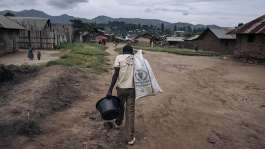 A man carries supplies through Kishishe, eastern Democratic Republic of Congo. Fighting in eastern DRC has displaced millions of people as Rwanda and the DRC seek to implement a US-brokered peace agreement. -  Alexis Huguet / AFP