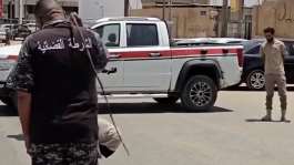 July 21st 2026, Sabha, Libya: a woman is sentenced to 100 lashes for adultery. She is seen kneeling on a mattress in the middle of a street blocked by a judicial police vehicle. One officer reads out the verdict, then another carries out the sentence.  Instagram / @feminists_of_libya -  Instagram / @feminists_of_libya