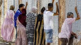 Families watch as migrants return after crossing the border into the Spanish enclave of Ceuta, at the Bab Ceuta border post near the town of Fnideq, Morocco on August 2, 2026. -  Abdel Majid Bziouat, AFP