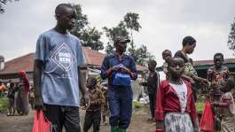 Children from Kibumba carry their school supplies home after a distribution by the women-led NGO Woman Power DRC ahead of the school reopening in Kibumba, on 28 August, 2025. -  JOSPIN MWISHA / AFP