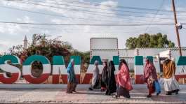 Women walk in front of a Somaliland sign in the city of Hargeisa. In a September 6, 2022, letter, the minister of information Suleyman Yusuf Ali, also known as Koore, said he was revoking CBA TV's right to operate in Somaliland. AFPEduardo Soteras