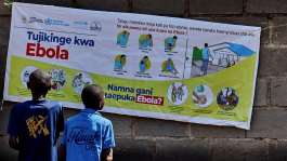 Congolese children read an Ebola awareness poster in Bunia, Ituri province, in the Democratic Republic of Congo. - REUTERS - Gradel Muyisa Mumbere
