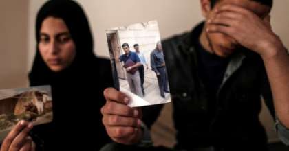The daughter and son (pictured April 2019) of Zaki Mubarak, whose body was transferred to Cairo after Ankara said he had committed suicide in prison, hold his picture during an interview in their family home. By MAHMUD HAMS (AFP/File)