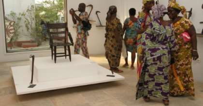 Visitors contemplate artefacts recently returned to Benin and on show at Cotonou's
