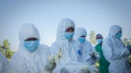 Volunteers putting on their personal protective equipment in Bunia, the capital of the DR Congos Ituri province.  By Benediction MURHABAZI (AFP)