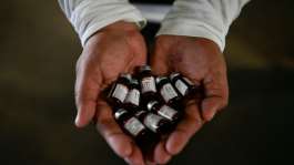 A health ministry worker showing vaccine doses for an immunisation campaign in Guatemala.  By JOHAN ORDONEZ (AFP)