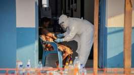 A healthcare worker taking samples from an Ebola patient in Bunia, northeastern DR Congo.  By Benediction MURHABAZI (AFP)