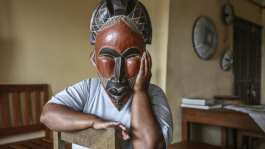 A woman deported from the US to Cameroon in an immigration crackdown shields her face with a mask as she poses for a photograph in Yaounde on September 9, 2026.  By - (AFP)