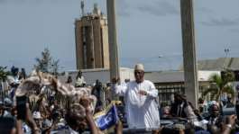 Ex-Senegalese president Macky Sall acknowledges the crowd outside Leopold Sedar Senghor Military Airport, after landing in Dakar on July 17, 2026.  By Patrick MEINHARDT (AFP)