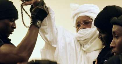 Former Chadian dictator Hissene Habre (C, pictured being escorted to court in 2015) has been granted two months' leave from prison as his jail is being used for new detainees in coronavirus quarantine. By SEYLLOU (AFP/File)