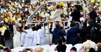 Many of the faithful wore pope-emblazoned white and yellow caps -- the colours of the Vatican, and cheered as the pope-mobile made its way through wind-swept clouds of red dust. By Tiziana FABI (AFP)