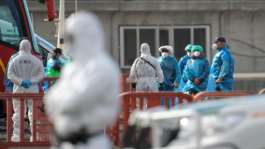 Passengers wearing blue protective suits were evacuated from the cruise ship MV Hondius on the Spanish island of Tenerife.  By JORGE GUERRERO (AFP)