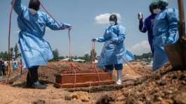 Red Cross and Red Crescent workers in Ituri bury an orphan who died of Ebola.  By Jospin Mwisha (AFP)