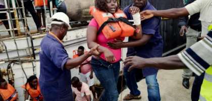 Rescued passengers are disembarked from a rescue vessel at the port of Santo Antonio on Principe after a passenger ship sank. By Maique Madeira (AFP)