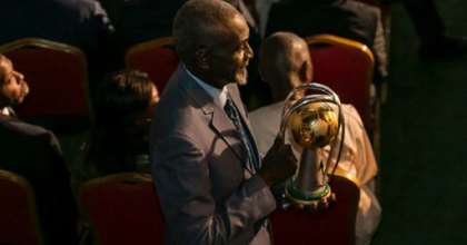 Stephen Tataw carries the trophy of the African Championship of Nations (CHAN) to the stage during the draw ceremony in Yaounde in February. By STRINGER (AFP/File)